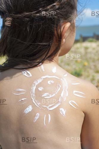 Girl with suncream on back