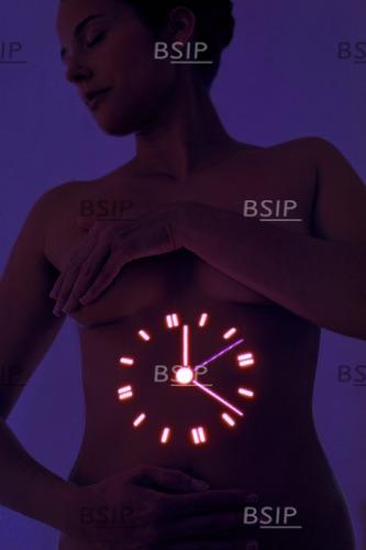 Woman with clock projected on stomach