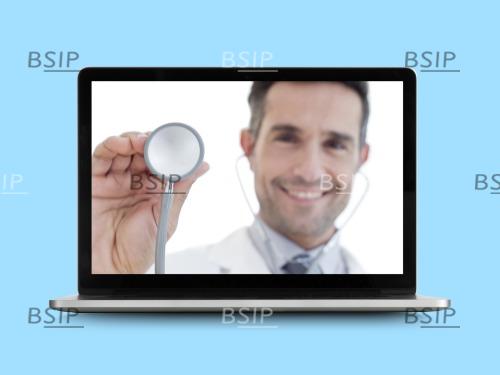 Doctor with stethoscope on laptop monitor